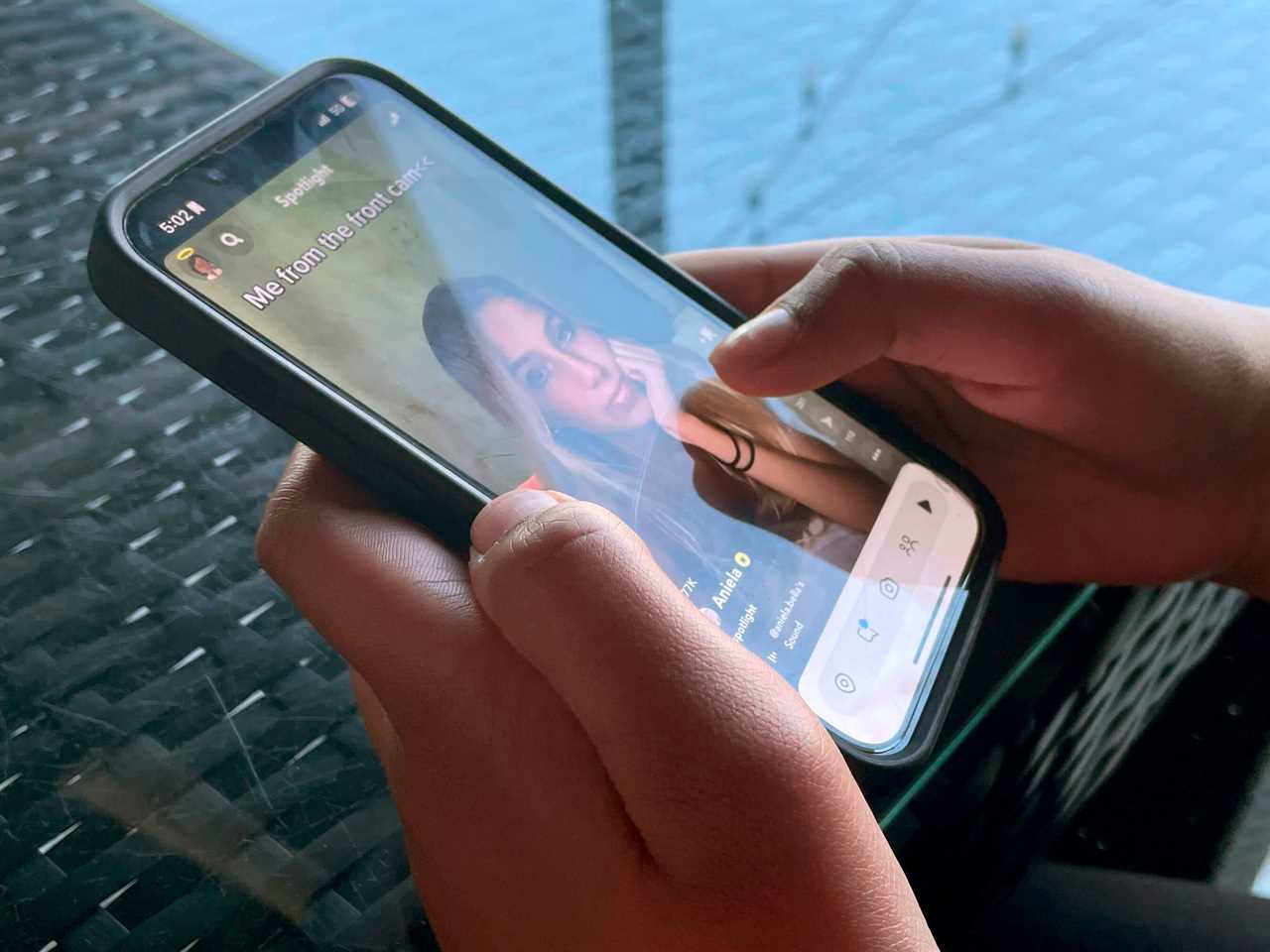 A person scrolls through a social media app.