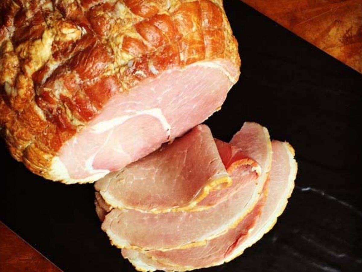 A view from above of a partially sliced Smoking Goose Pecan Smoked Duroc Ham.