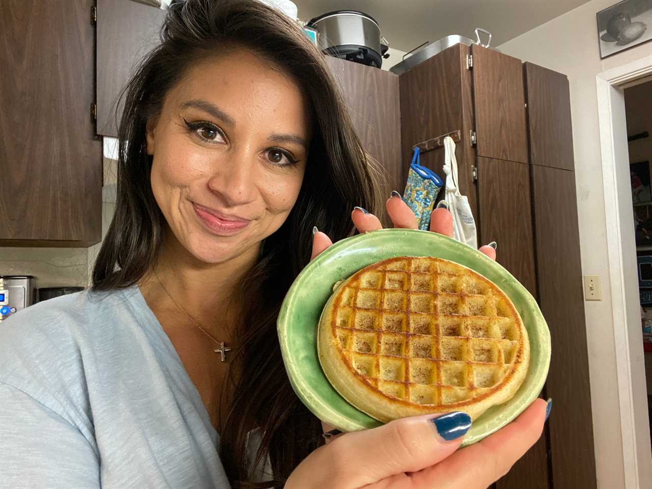 chelsea holding up a frozen waffle on a plate