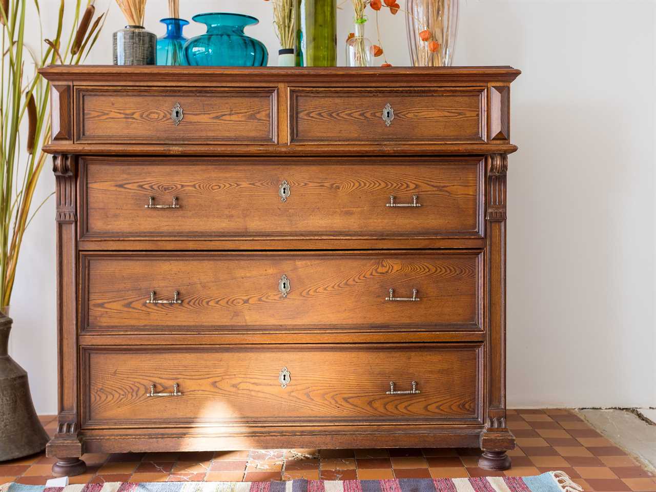 Thrifted wooden chest with glassware on top