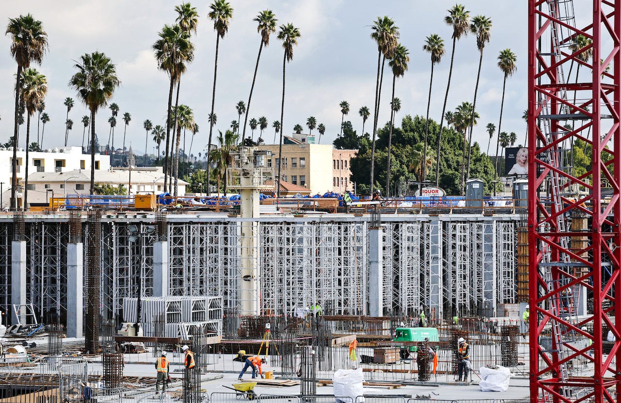 Construction workers help build a mixed-use apartment complex which will hold over 700 units of apartment housing and 95,000 square feet of commercial space on January 25, 2024 in Los Angeles, California.