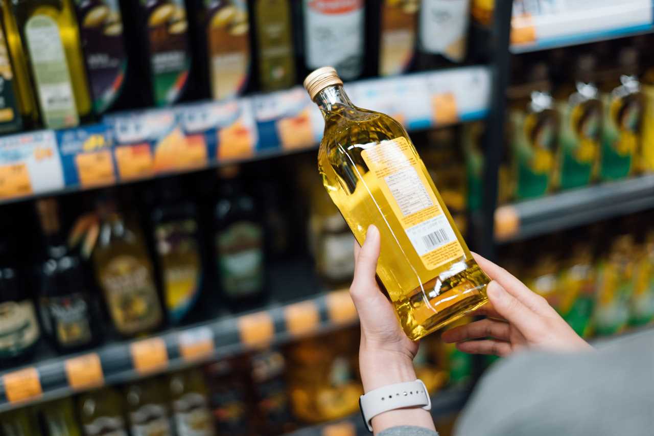 Woman looking at a bottle of cooking oil.