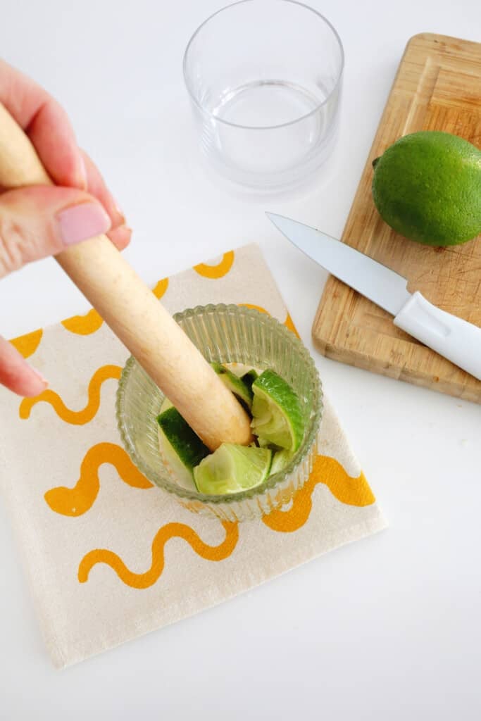 muddling a Caipirinha drink 